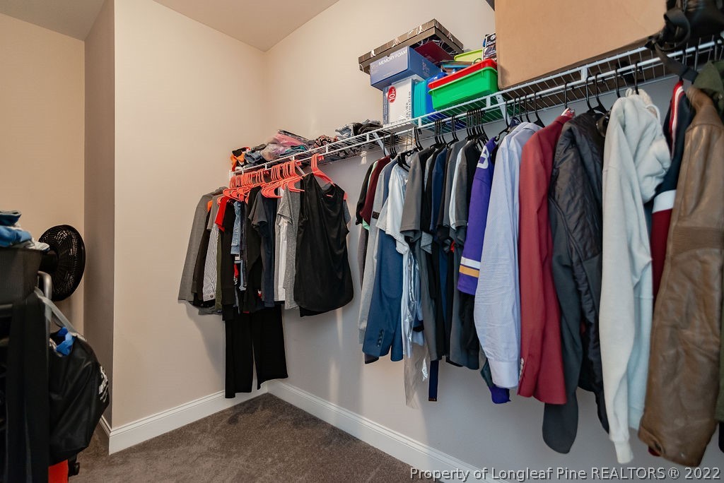 335 Turriff Way Cameron, NC 28326 - Photo 28 of 50 a view of walk in closet with clothes