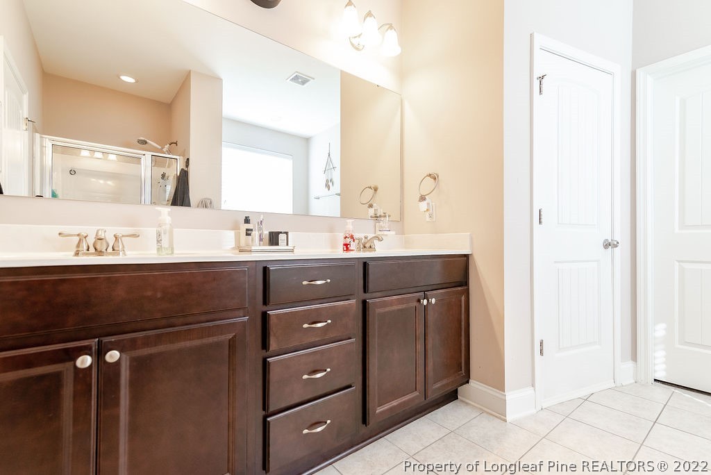 335 Turriff Way Cameron, NC 28326 - Photo 31 of 50 a bathroom with a sink vanity and mirror