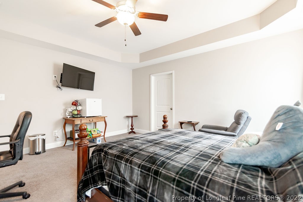 335 Turriff Way Cameron, NC 28326 - Photo 35 of 50 a bedroom with a bed and a flat screen tv