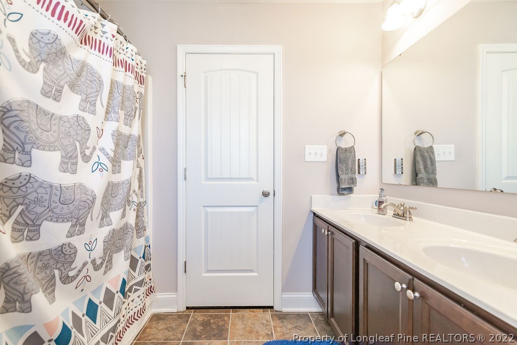 335 Turriff Way Cameron, NC 28326 - Photo 40 of 50 a bathroom with a sink and a mirror