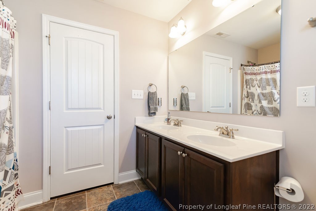 335 Turriff Way Cameron, NC 28326 - Photo 41 of 50 a bathroom with a sink and a mirror