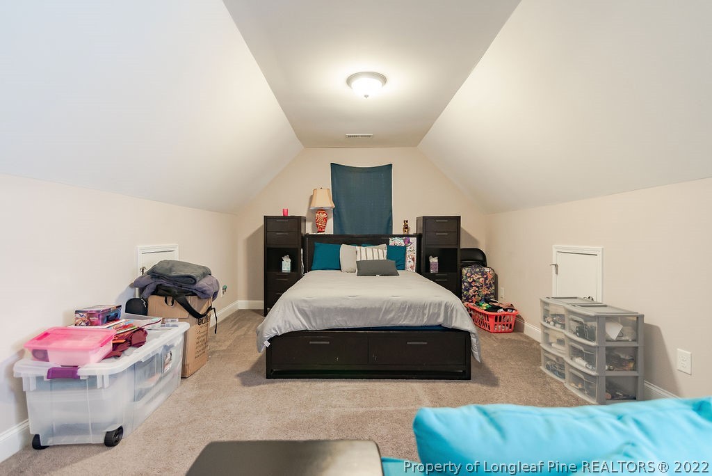 335 Turriff Way Cameron, NC 28326 - Photo 44 of 50 a bedroom with furniture and a bed