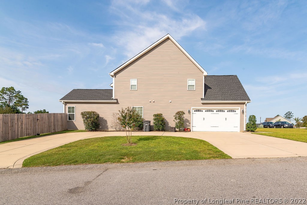 335 Turriff Way Cameron, NC 28326 - Photo 5 of 50 a front view of a house with a yard and garage