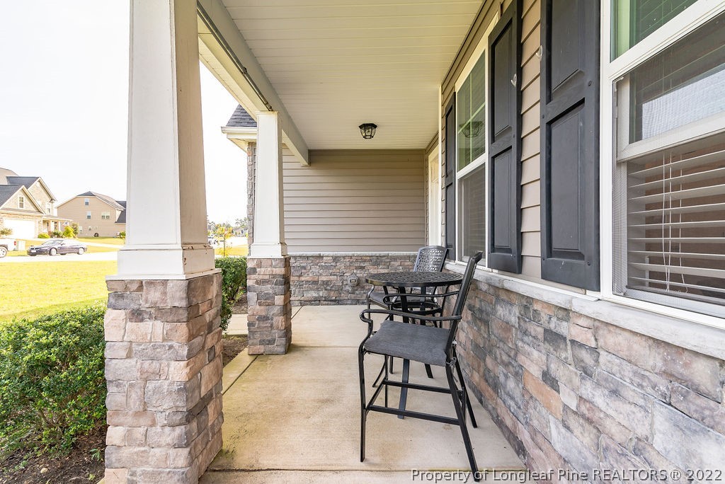 335 Turriff Way Cameron, NC 28326 - Photo 7 of 50 a balcony with table and chairs and potted plants
