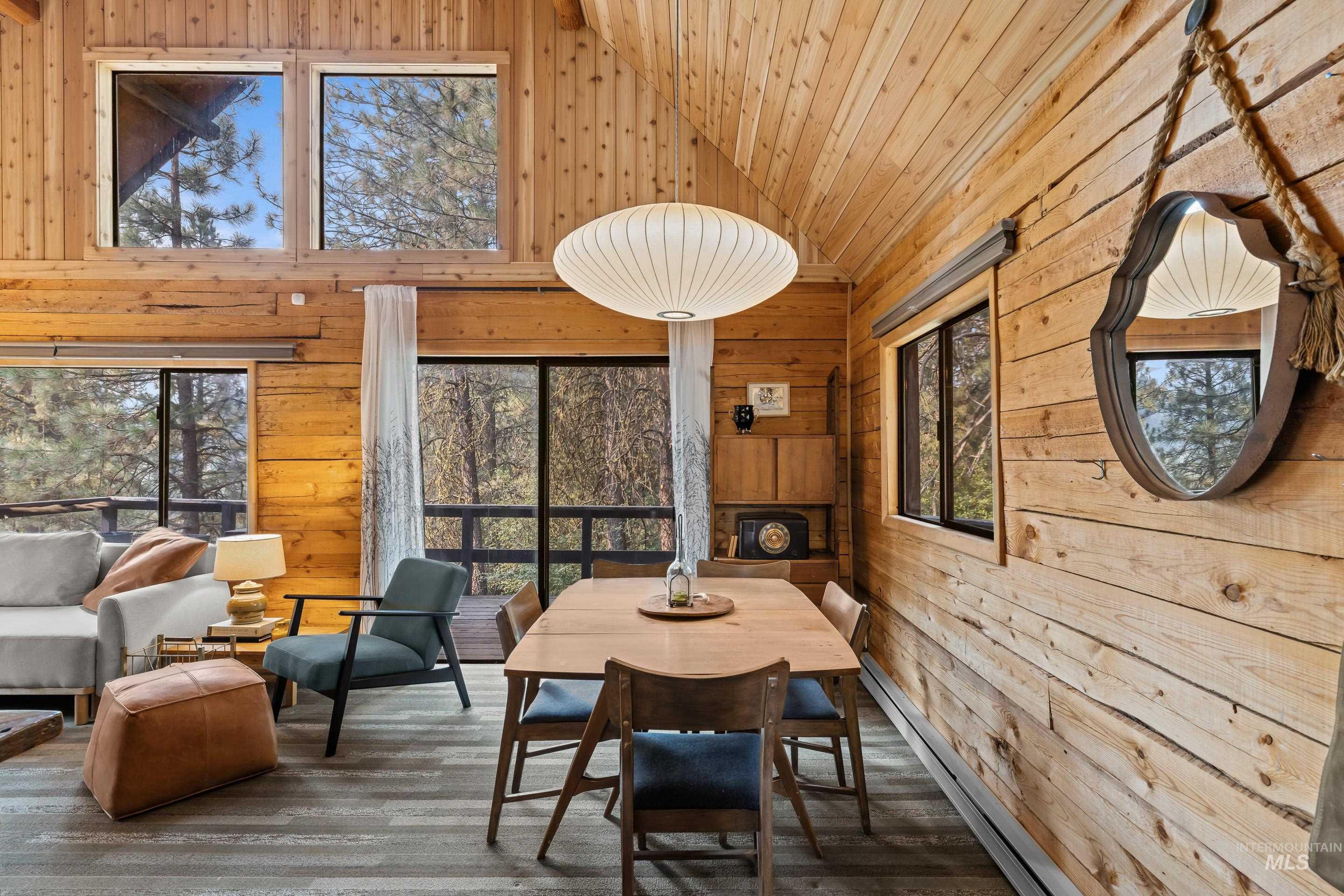 73 Rainbow Ridge Road Garden Valley, ID 83622 - Photo 17 of 49 Vaulted ceiling with wood paneling, wood-finish flooring, exposed wood beam construction, and large windows