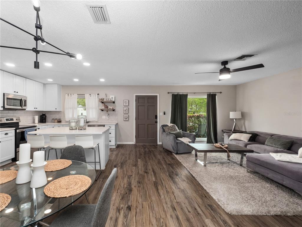 2733 Middle Street Orlando, FL 32807 - Photo 12 of 23 a living room with furniture kitchen view and a wooden floor