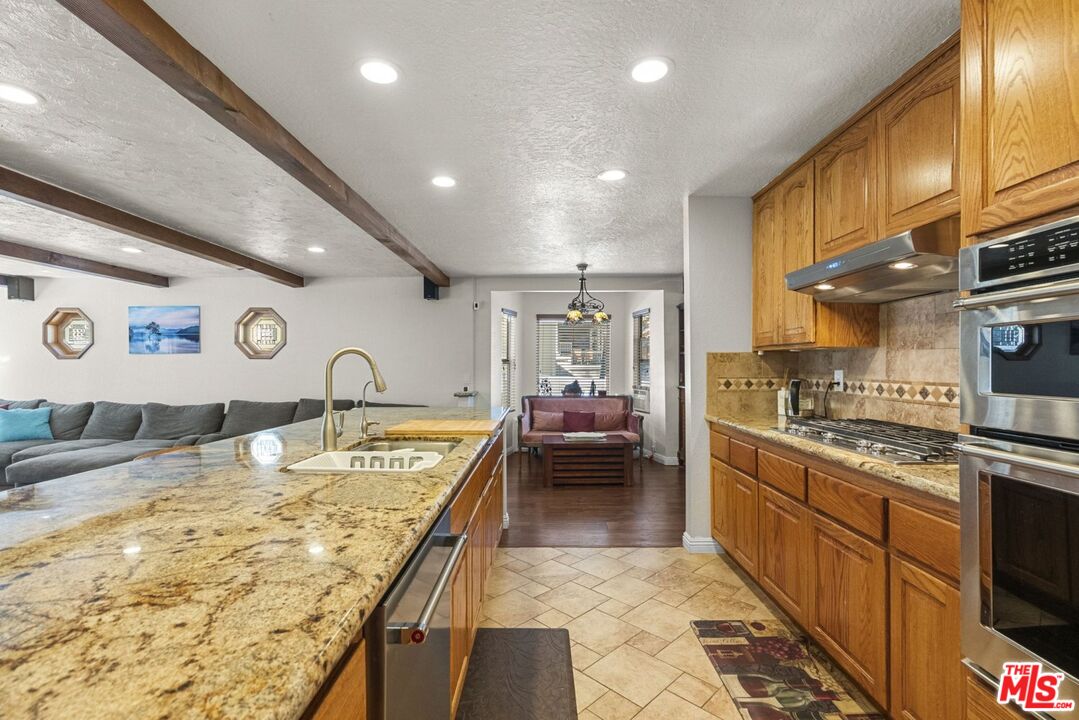 1197 Oriole Road Wrightwood, CA 92397 - Photo 27 of 50 a large kitchen with stainless steel appliances granite countertop a lot of counter space and a sink