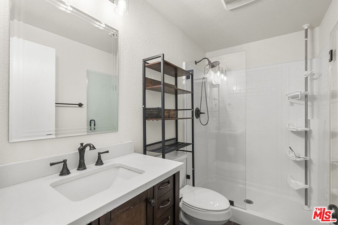 1197 Oriole Road Wrightwood, CA 92397 - Photo 29 of 50 a bathroom with a sink toilet vanity and shower