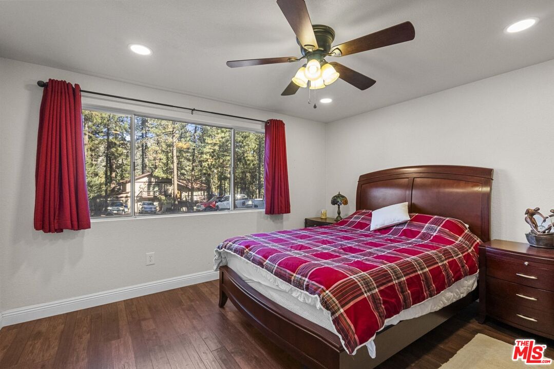 1197 Oriole Road Wrightwood, CA 92397 - Photo 31 of 50 a bedroom with a large bed and a chandelier