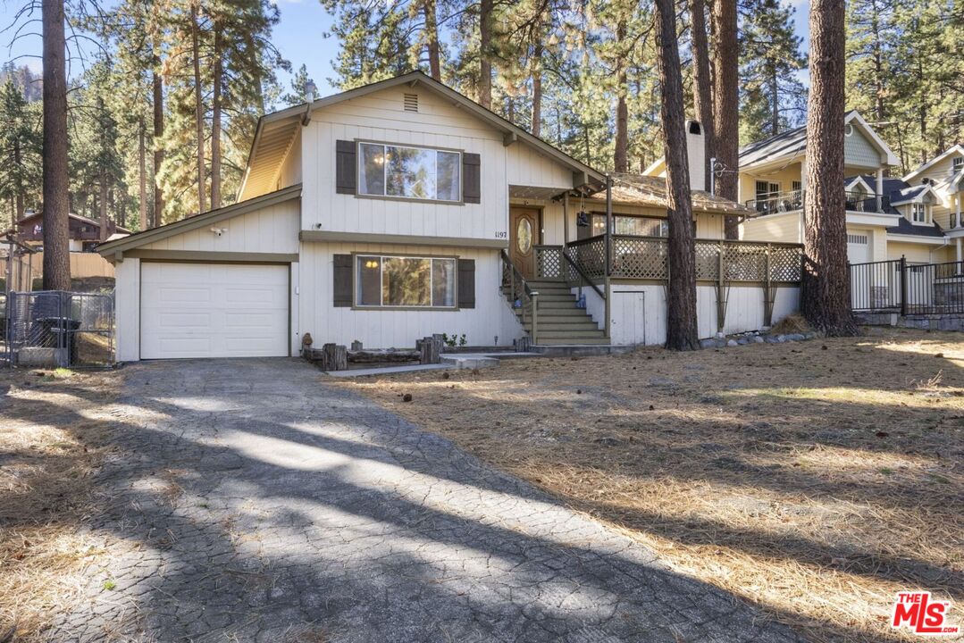 1197 Oriole Road Wrightwood, CA 92397 - Photo 38 of 50 a front view of a house with a yard and garage