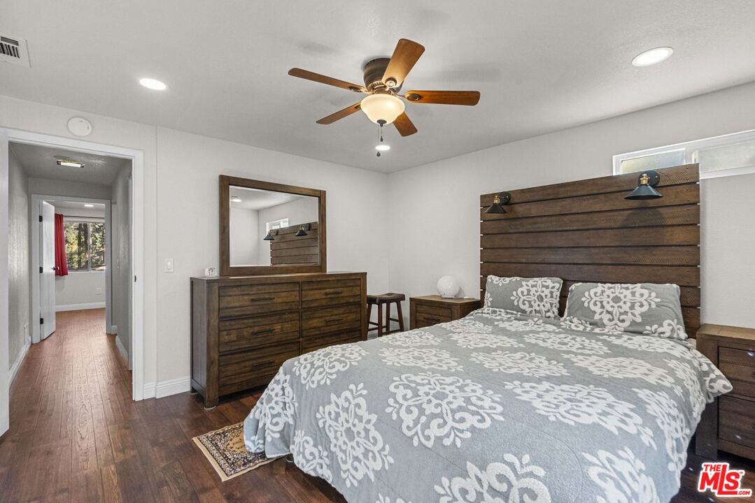 1197 Oriole Road Wrightwood, CA 92397 - Photo 8 of 50 a bedroom with a bed and wooden floor