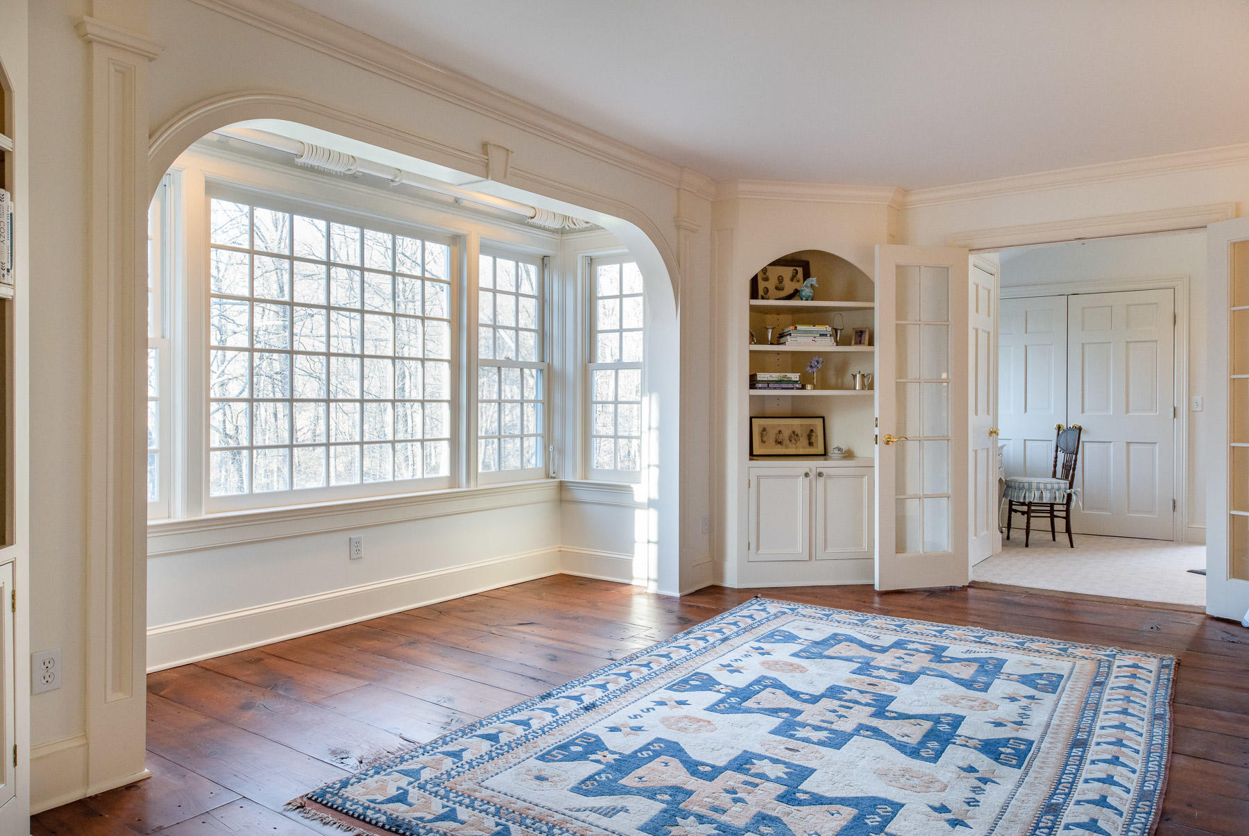 1403 Ponus Ridge Road New Canaan, CT 06840 - Photo 26 of 48 a bedroom with a bed and wooden floor