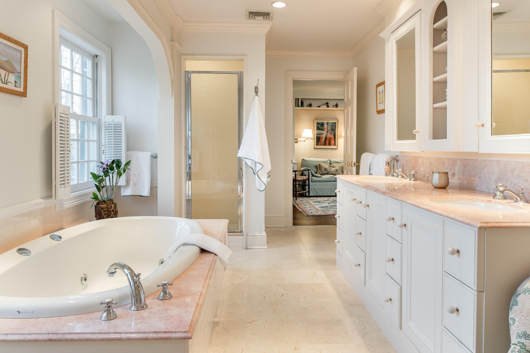 1403 Ponus Ridge Road New Canaan, CT 06840 - Photo 27 of 48 a bathroom with a tub a sink and a large mirror