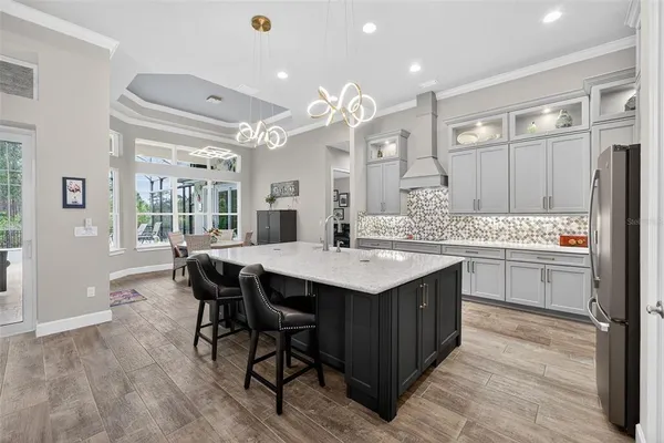 a spacious bedroom with a bed and a chandelier