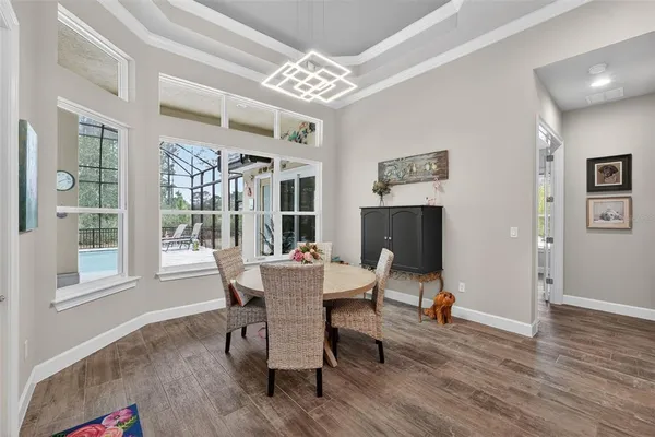 a spacious bathroom with a granite countertop sink a toilet a mirror and shower