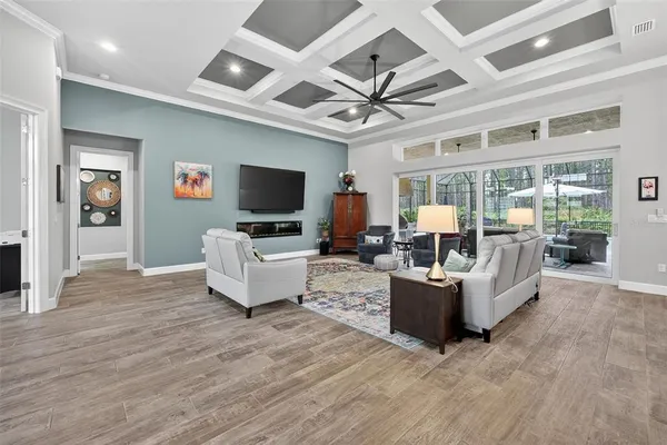 a spacious bedroom with a bed a table and painting on the wall