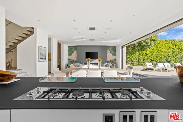 a kitchen with stainless steel appliances a stove a sink and a refrigerator