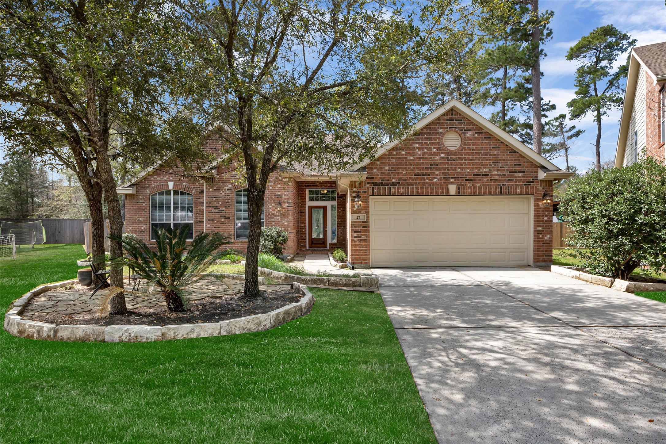a front view of a house with a garden