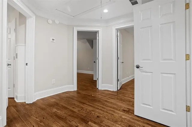 a bedroom with a bed and a potted plant on dresser