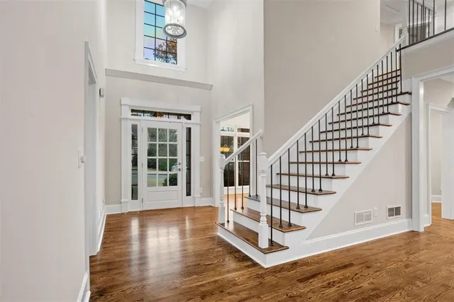 a view of entryway and hall with wooden floor