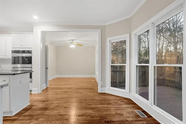 a kitchen with stainless steel appliances granite countertop a refrigerator and a stove top oven