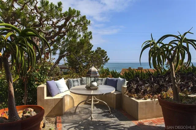 a view of a patio with table and chairs and potted plants