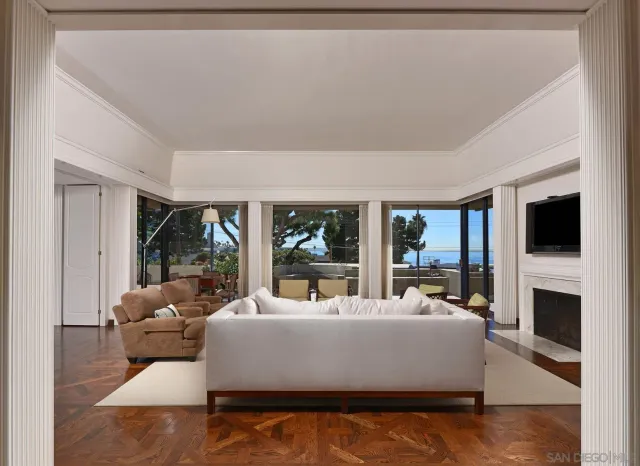 a living room with furniture large windows and a flat screen tv