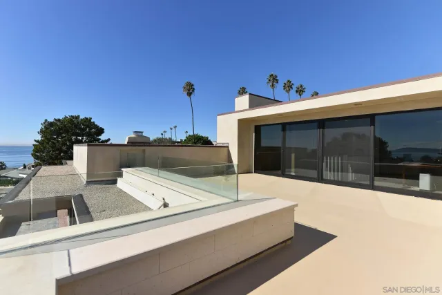 a roof deck with table and chairs and wooden floor