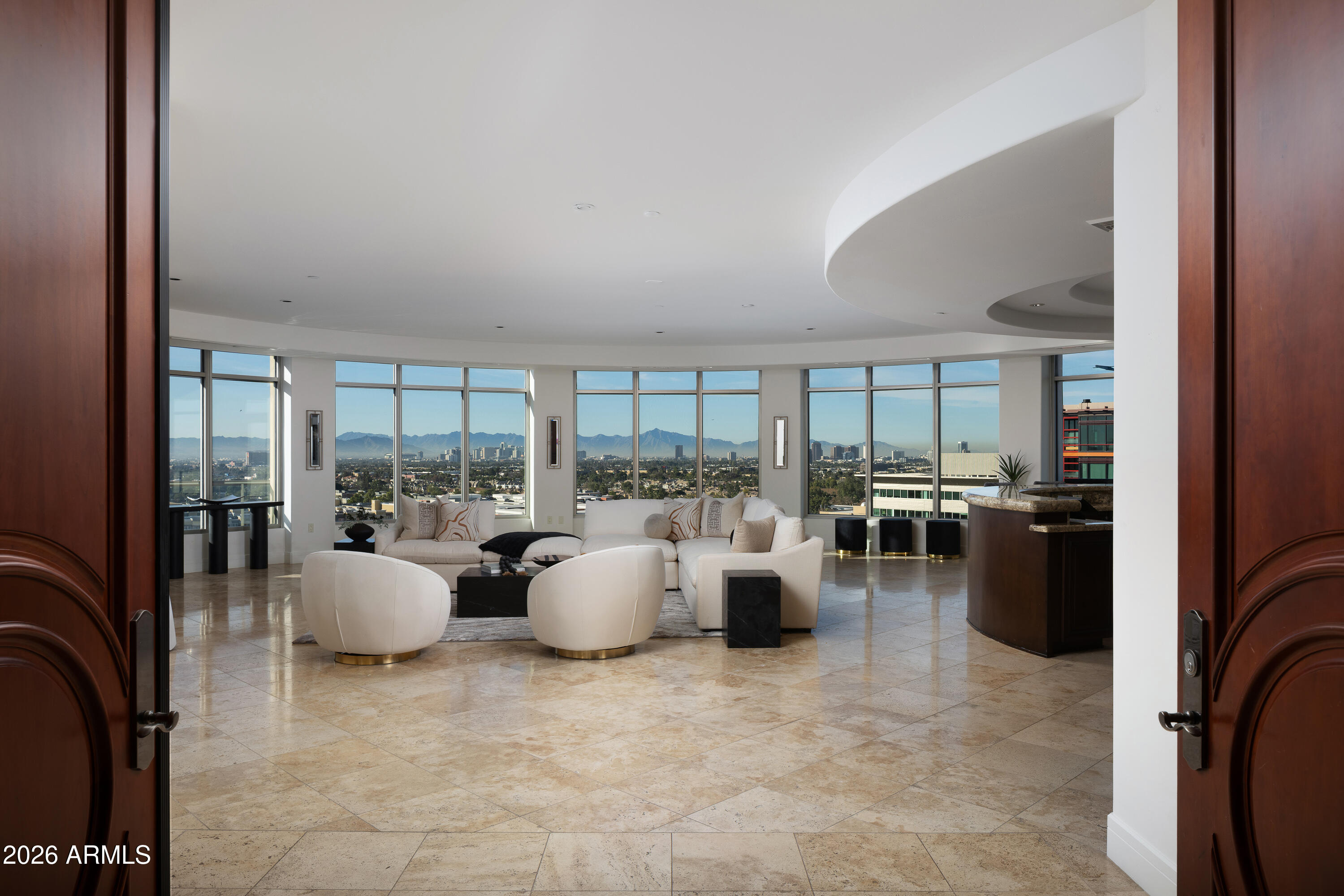 a view of a living room with furniture and floor to ceiling window