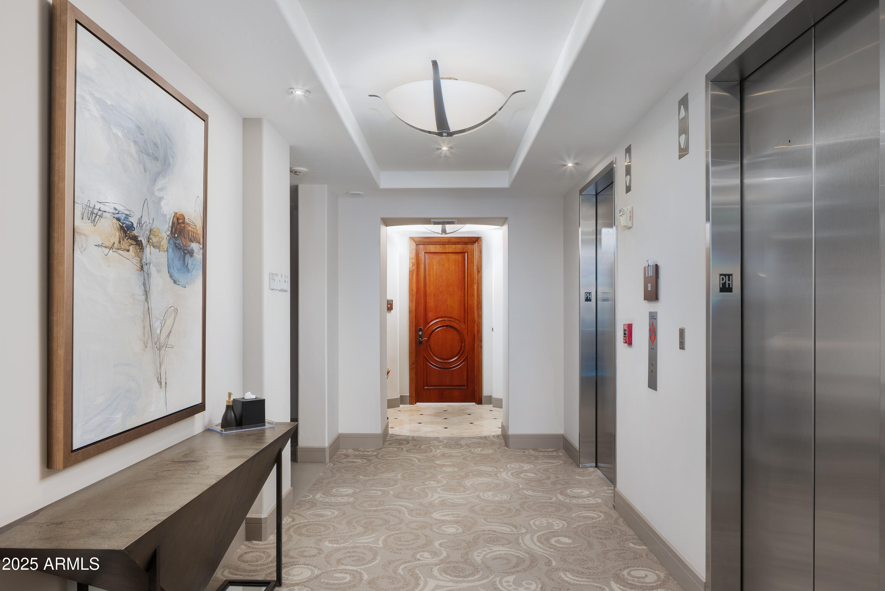2402 East Esplanade Lane, Unit PH2 Phoenix, AZ 85016 - Photo 31 of 40 a view of a hallway with wooden floor and a bathroom