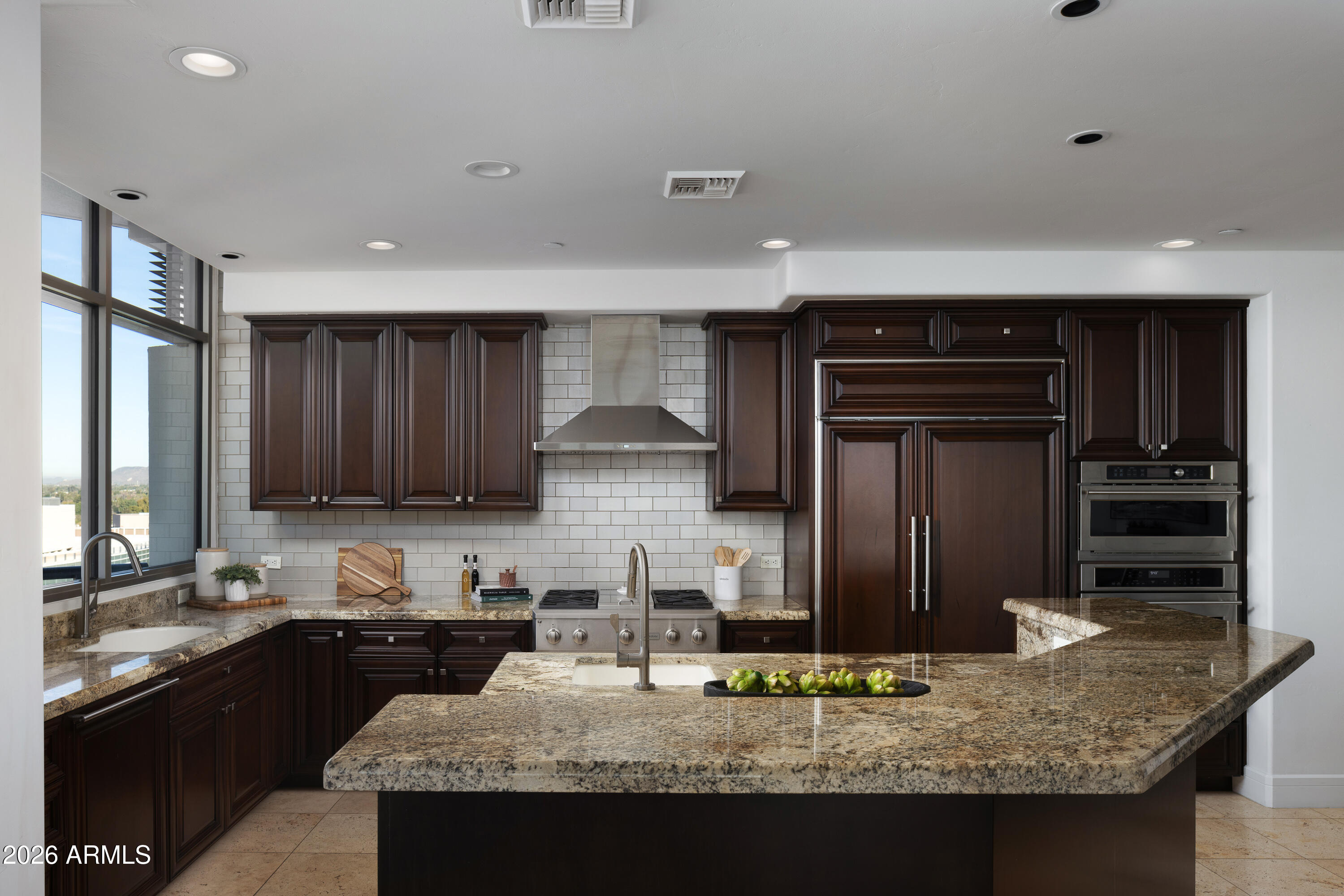 2402 East Esplanade Lane, Unit PH2 Phoenix, AZ 85016 - Photo 6 of 40 a kitchen with stainless steel appliances granite countertop a sink stove and refrigerator