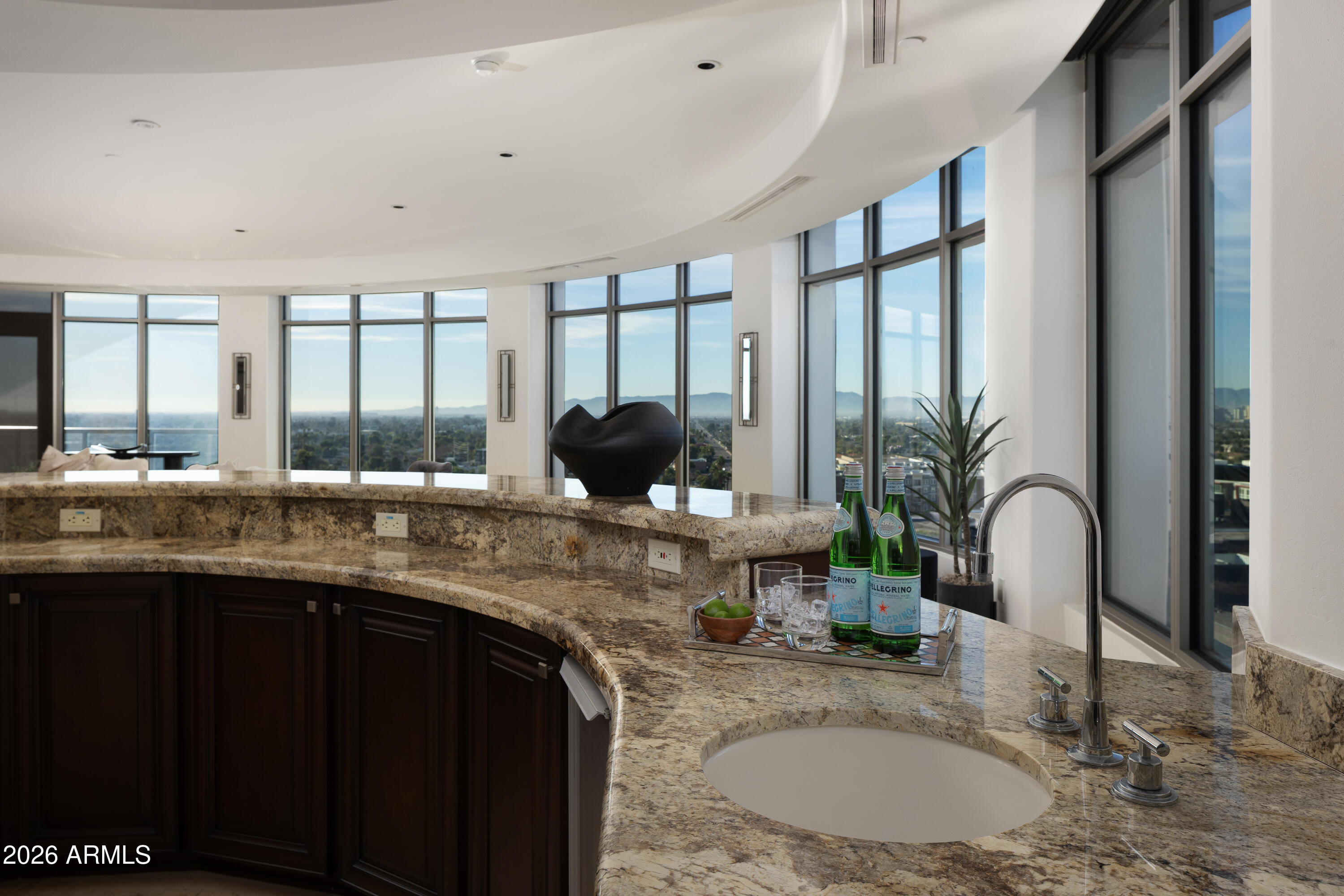 2402 East Esplanade Lane, Unit PH2 Phoenix, AZ 85016 - Photo 8 of 40 a kitchen with granite countertop a sink and a large window