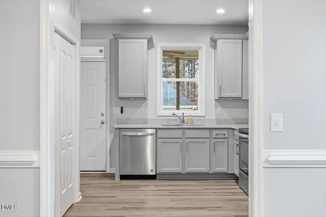 a spacious bathroom with a granite countertop sink and a mirror