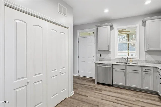 a spacious bathroom with a double vanity sink a mirror and a bathtub