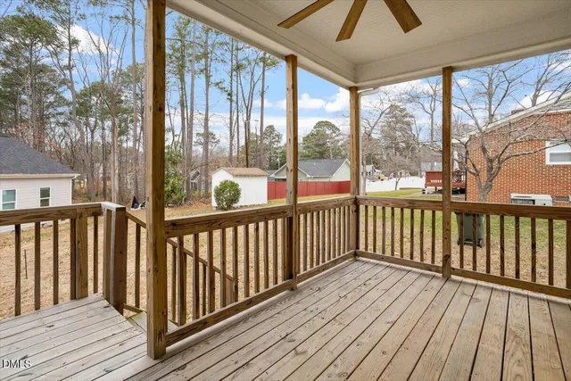 a view of balcony with wooden floor and fence