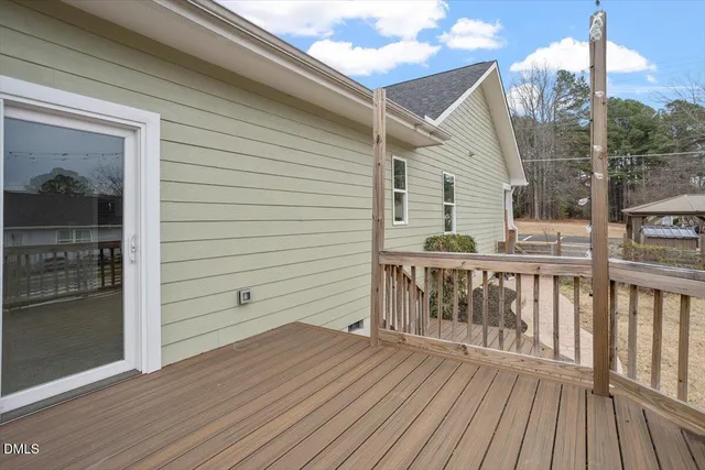 a view of a house with a wooden fence