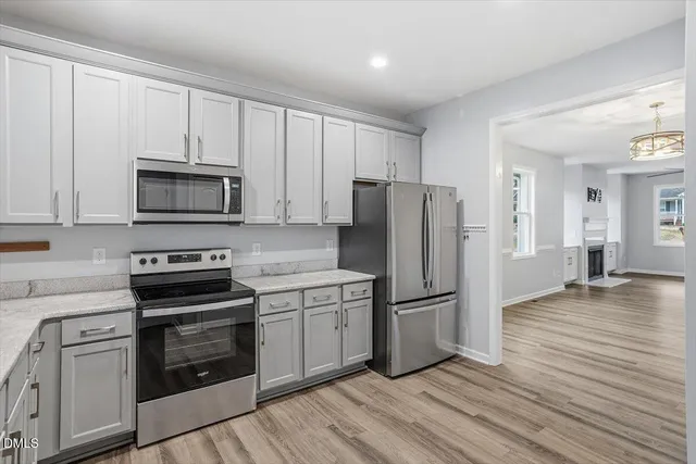 a kitchen with wooden cabinets and stainless steel appliances