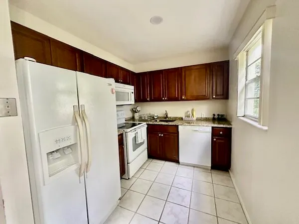 a white refrigerator freezer sitting inside of a kitchen