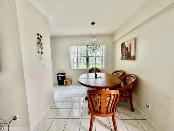a dining room with furniture and window