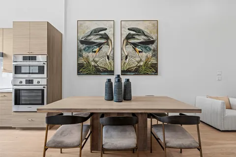 a kitchen with a table chairs sink and cabinets