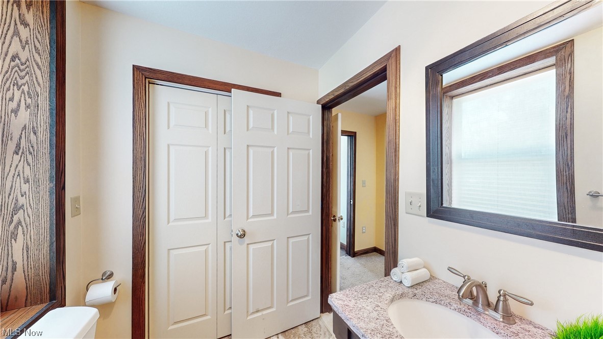 5770 Horning Road Kent, OH 44240 - Photo 23 of 50 1st floor Bathroom featuring toilet, large vanity, and plenty of natural light