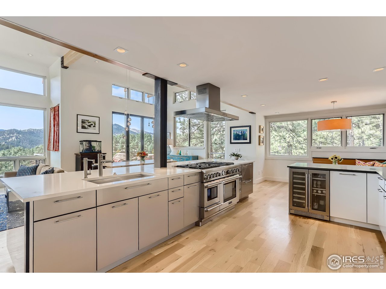 153 Poorman Road Boulder, CO 80302 - Photo 8 of 40 a large kitchen with granite countertop a stove top oven a sink a dining table and chairs