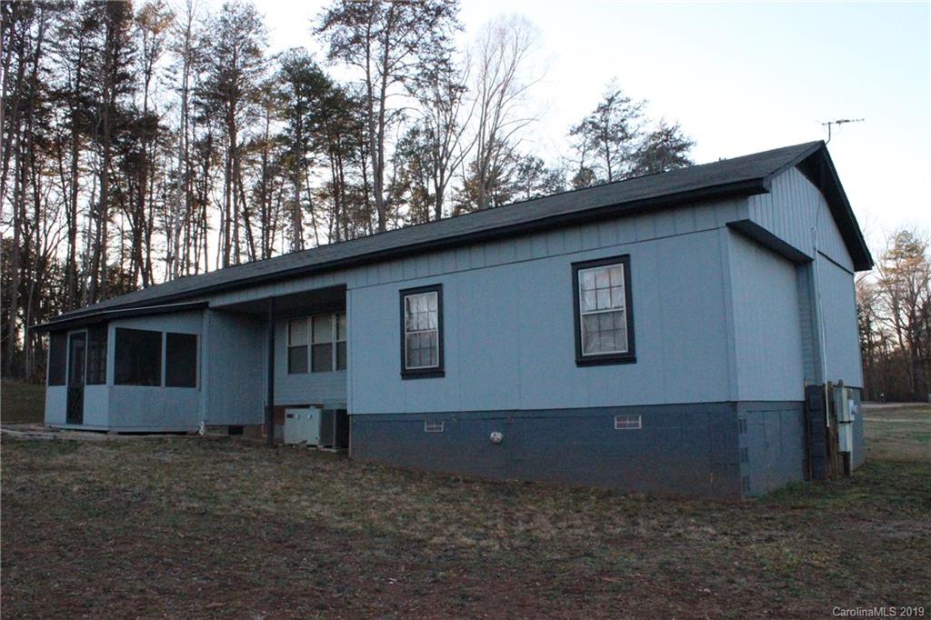 2856 Filbert Highway Clover, SC 29710 - Photo 11 of 11 a house covered with trees in the background