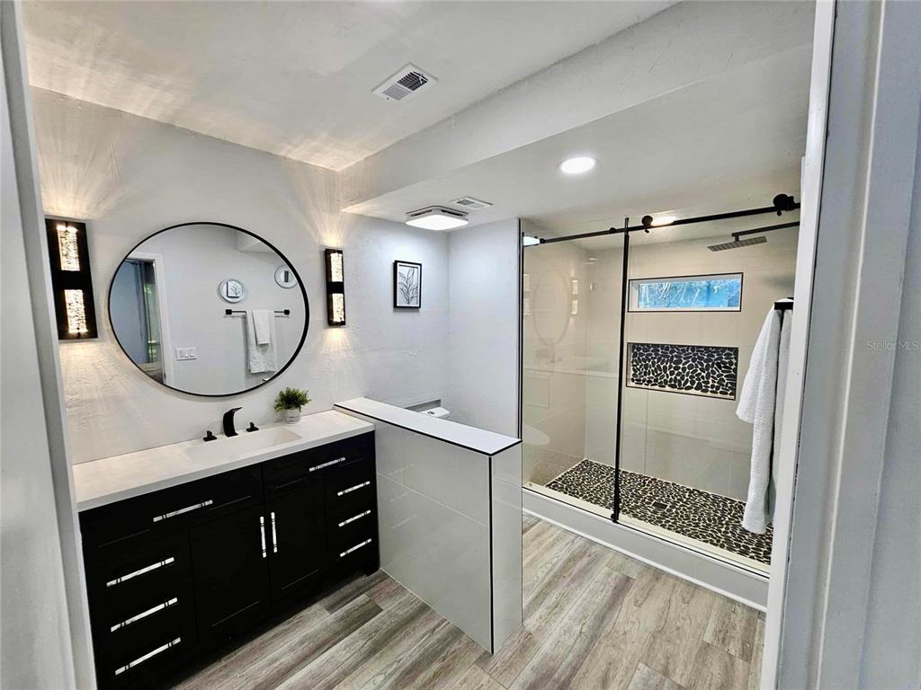 5407 Southwest 82 Terrace Gainesville, FL 32608 - Photo 15 of 31 a bathroom with a double vanity sink and a mirror