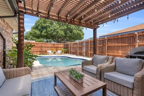 a view of patio with couches and pool