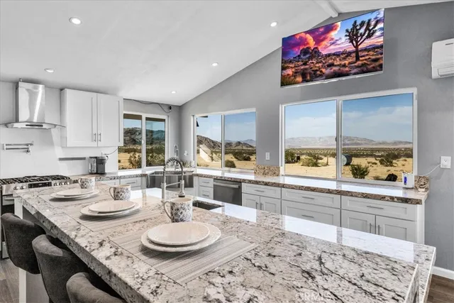 a kitchen with stainless steel appliances granite countertop a stove and cabinets