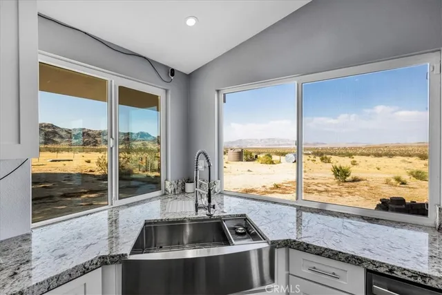 a kitchen with granite countertop cabinets and steel stainless steel appliances