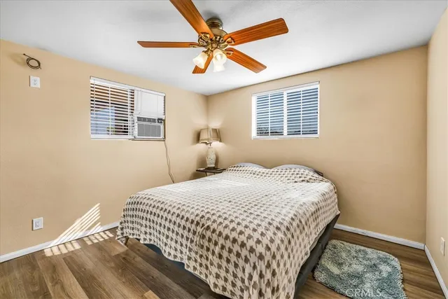 a view of a livingroom with a hardwood floor and a ceiling fan