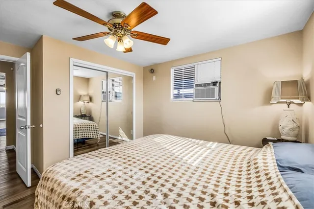 a view of an empty room with window and a ceiling fan