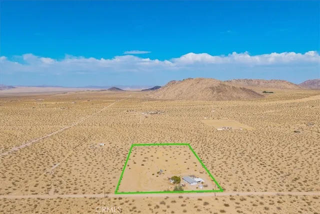 a view of a house with a snow on the road